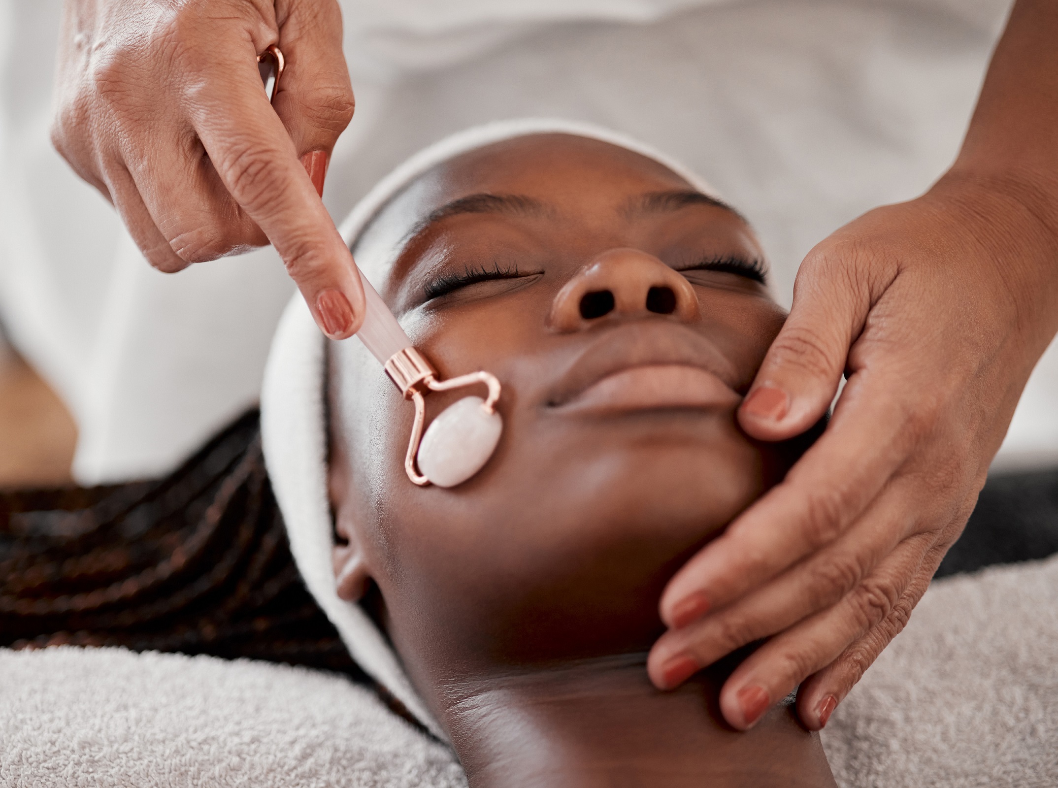 facial-roller-spa-black-woman-relax-massage-wellness-skincare-cosmetics-salon-beauty-face-beautician-with-rose-tool-healthy-dermatology-crystal-stone-aesthetic-glow