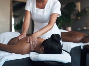 The best way to destress. a young woman getting a back massage at a spa.